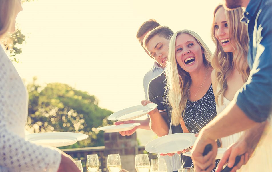 Mennesker som smiler og er på sommerfest