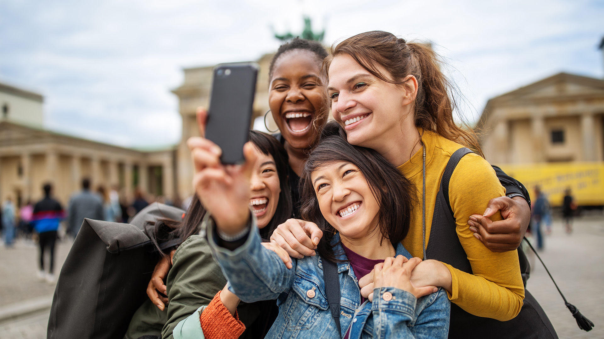 En gruppe vennegjeng som tar bilder på mobilen